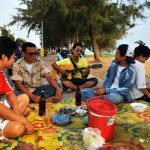 Thai family eating next to the beach in Rayong town