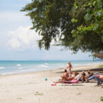 Holiday goers relaxing at Mae Ramphung beach